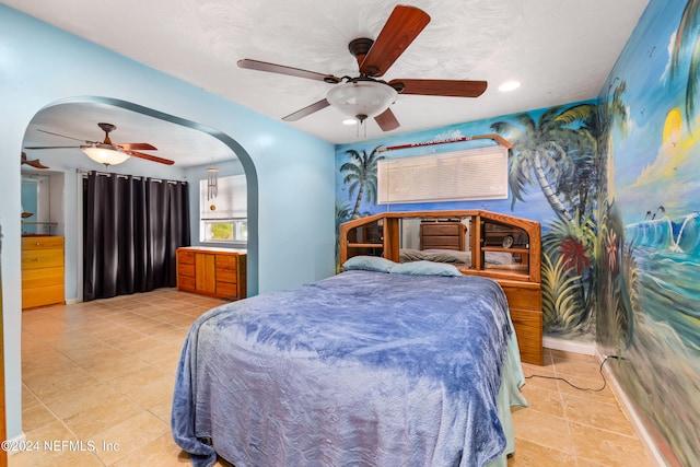 tiled bedroom featuring ceiling fan