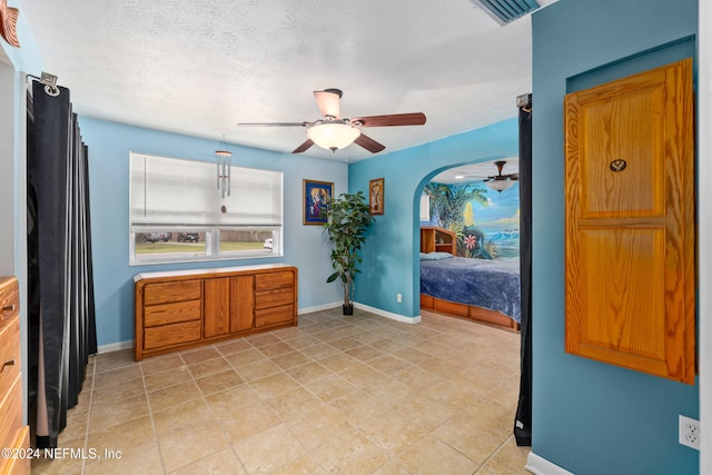 kitchen featuring light tile patterned floors, a textured ceiling, and ceiling fan