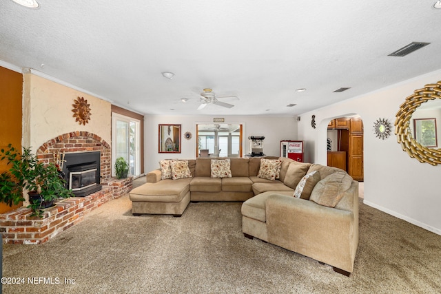 living room with carpet, a textured ceiling, a wealth of natural light, and ceiling fan