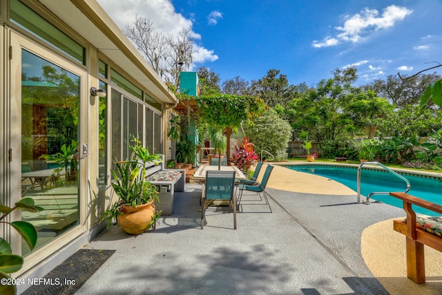 view of swimming pool with a patio