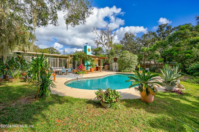 view of swimming pool featuring a lawn and a patio area