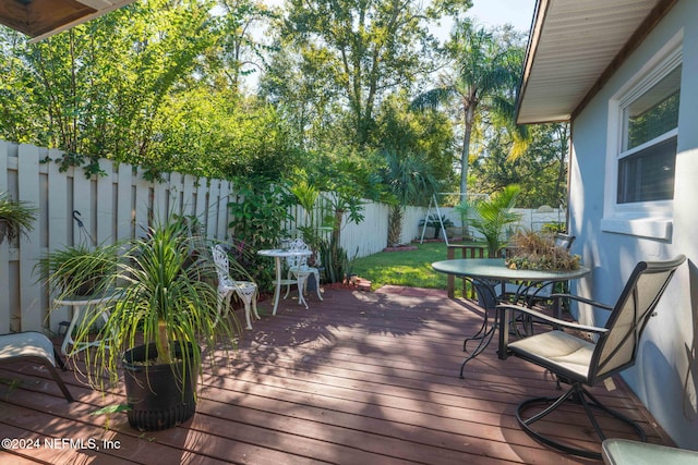 wooden deck with a lawn