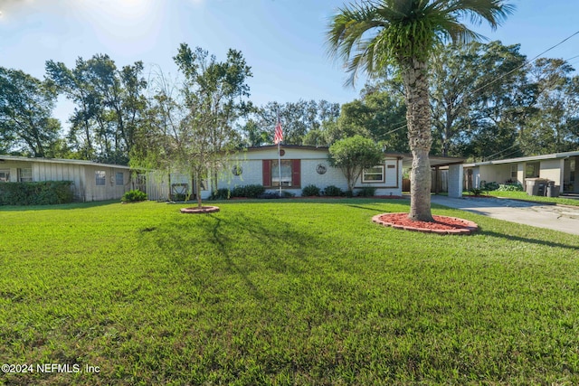 single story home with a front yard and a carport