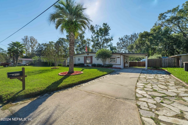 ranch-style home with a front yard and a carport