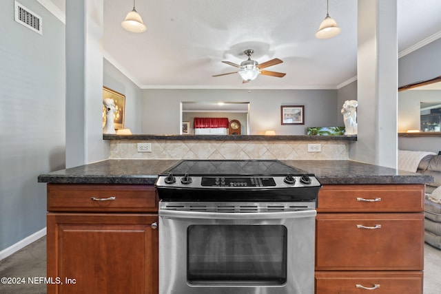 kitchen featuring crown molding, carpet floors, hanging light fixtures, and stainless steel electric range