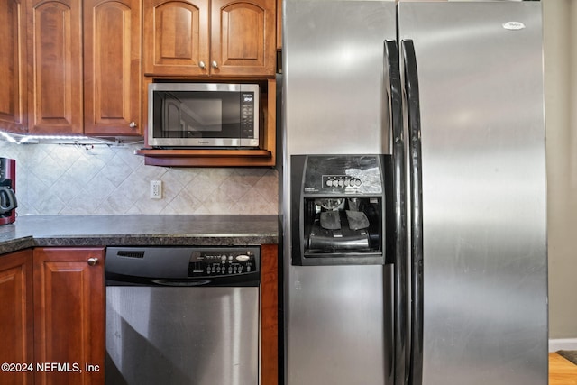 kitchen with backsplash and appliances with stainless steel finishes