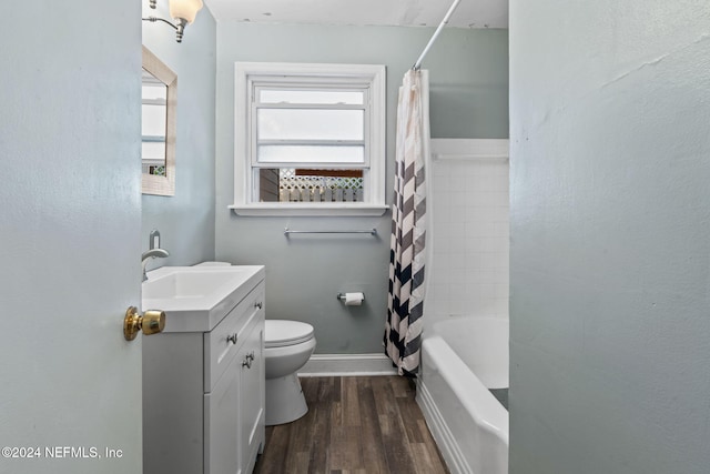 full bathroom with shower / bath combo with shower curtain, vanity, wood-type flooring, and toilet