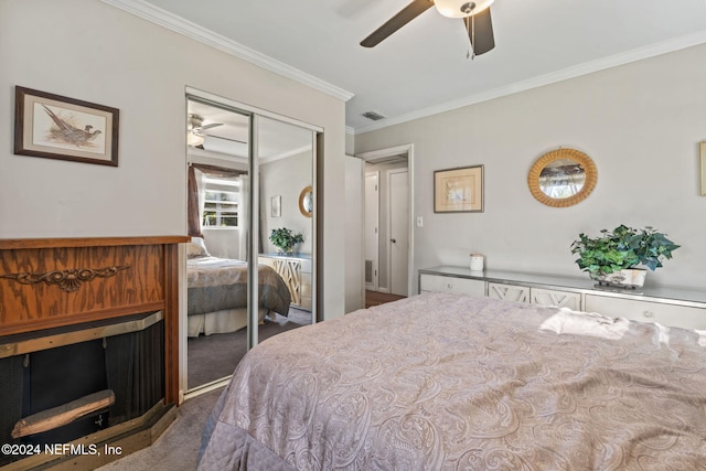 carpeted bedroom featuring ceiling fan, a closet, and ornamental molding