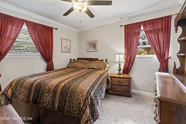 carpeted bedroom featuring ceiling fan, a textured ceiling, and ornamental molding