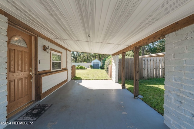 view of patio / terrace featuring a storage unit