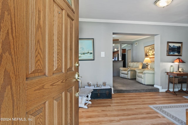 entrance foyer with wood-type flooring and crown molding