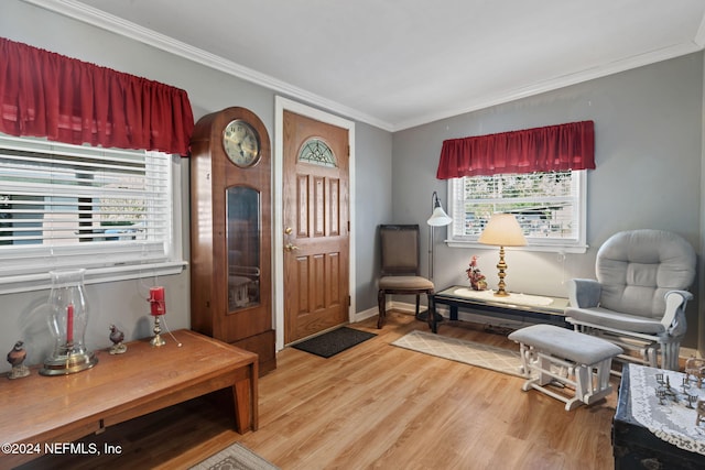 sitting room with hardwood / wood-style floors, plenty of natural light, and crown molding