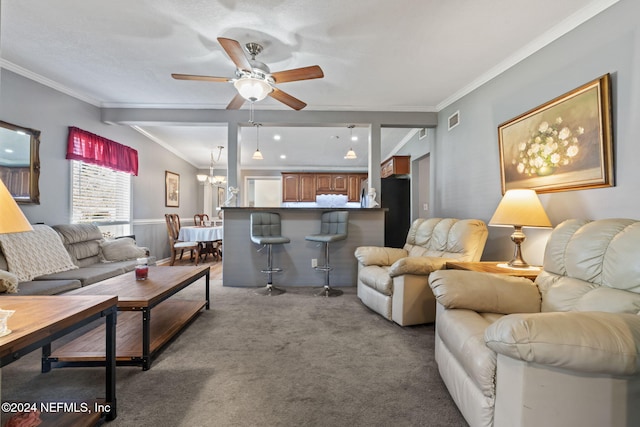 carpeted living room featuring crown molding and ceiling fan with notable chandelier