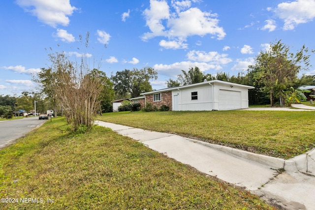 view of front of house with a front yard and a garage