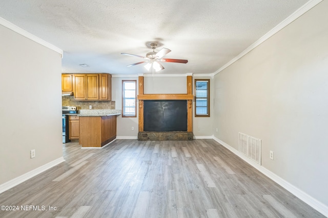 unfurnished living room featuring a textured ceiling, light hardwood / wood-style flooring, ceiling fan, and crown molding