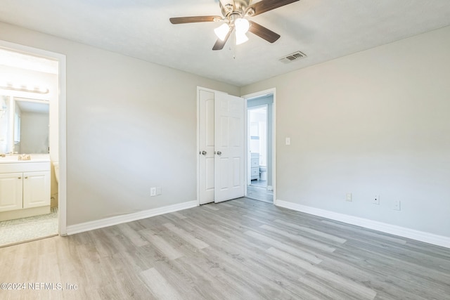 unfurnished bedroom with ceiling fan, light hardwood / wood-style flooring, and ensuite bath