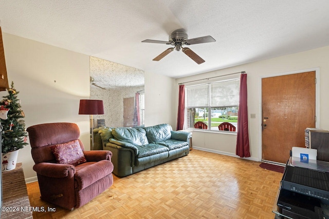 living room featuring light parquet flooring, a textured ceiling, and ceiling fan