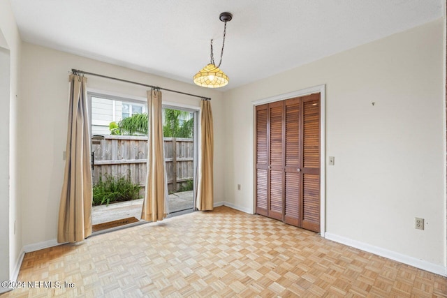 interior space with light parquet floors and a textured ceiling