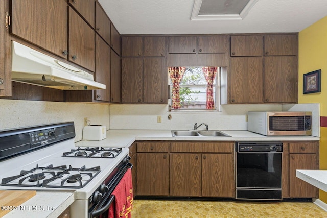 kitchen with gas range gas stove, sink, dark brown cabinetry, and black dishwasher