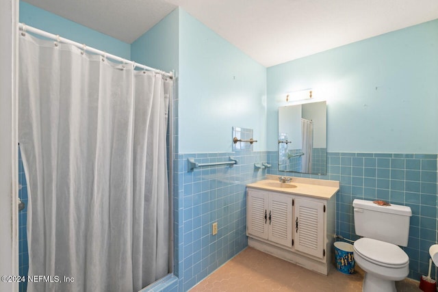 bathroom with vanity, tile walls, a shower with shower curtain, and tile patterned floors