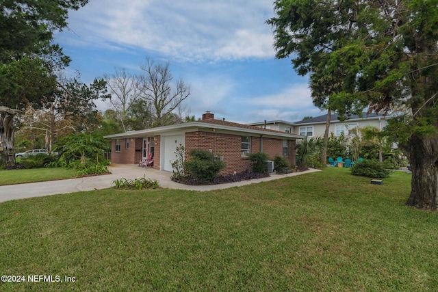 ranch-style house with central AC unit and a front lawn