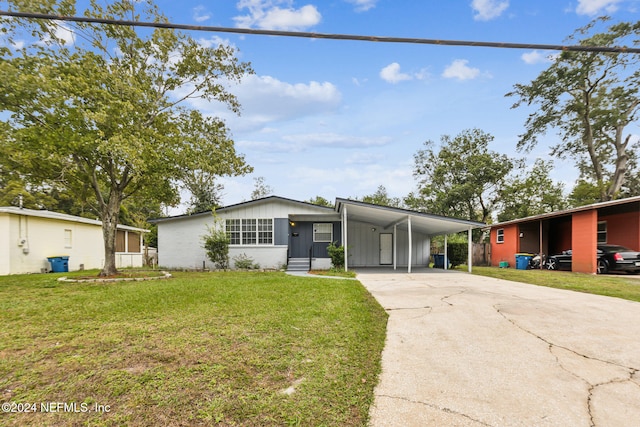 ranch-style house with a front yard and a carport