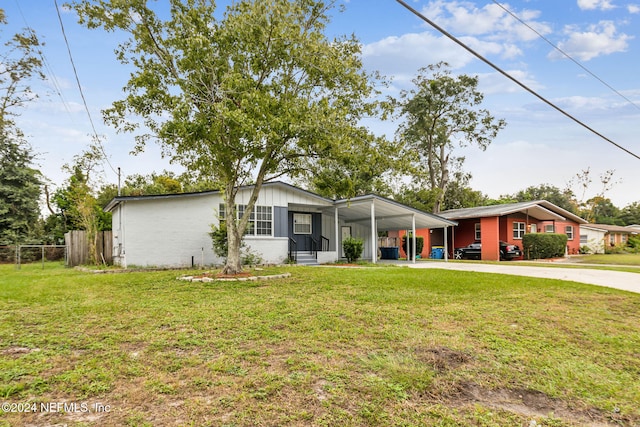 ranch-style home with a carport and a front lawn