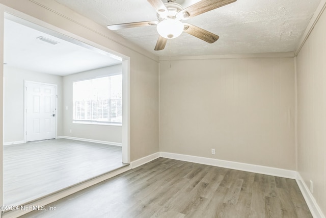 unfurnished room with hardwood / wood-style floors, ceiling fan, and a textured ceiling