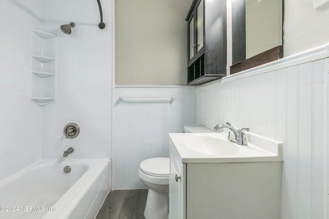 full bathroom with toilet, hardwood / wood-style floors, vanity, and tiled shower / bath combo