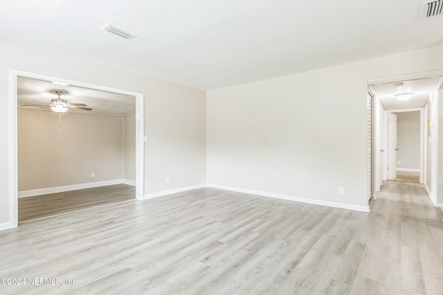 spare room with light hardwood / wood-style flooring and ceiling fan