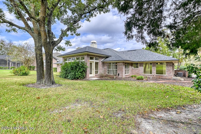 back of property featuring a lawn