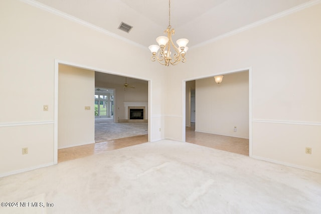 spare room featuring carpet, ceiling fan with notable chandelier, and ornamental molding