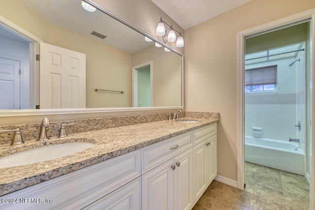 bathroom featuring vanity and  shower combination