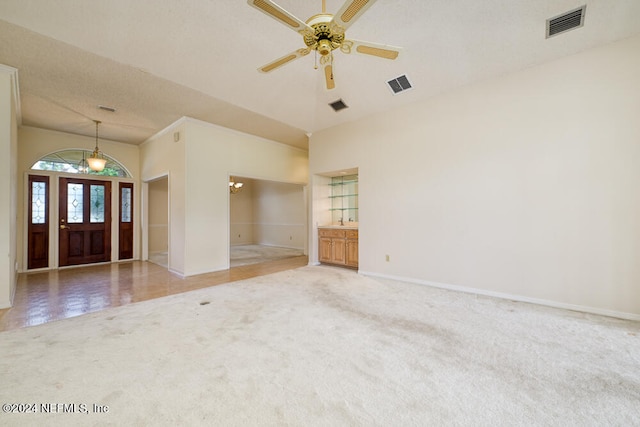 carpeted empty room with a textured ceiling and ceiling fan