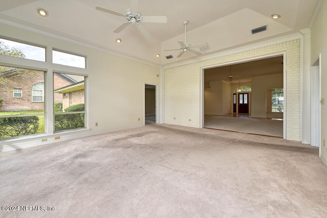 carpeted empty room featuring crown molding, high vaulted ceiling, and ceiling fan