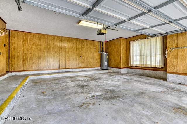 garage with electric water heater, wooden walls, and a garage door opener