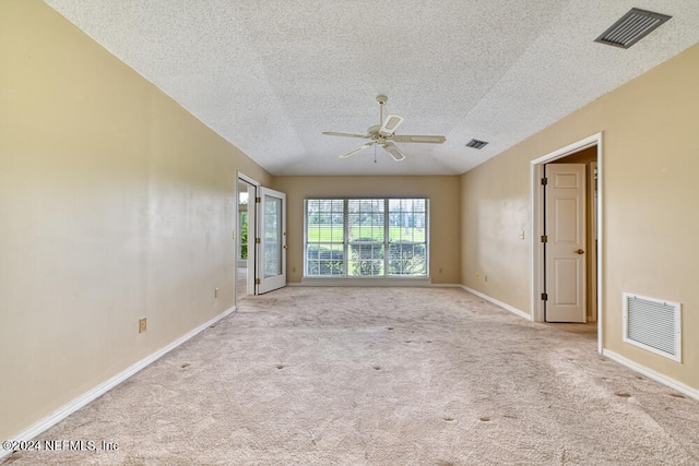 carpeted empty room featuring ceiling fan and a textured ceiling