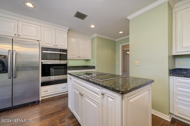 kitchen with appliances with stainless steel finishes, dark hardwood / wood-style flooring, crown molding, dark stone countertops, and white cabinetry