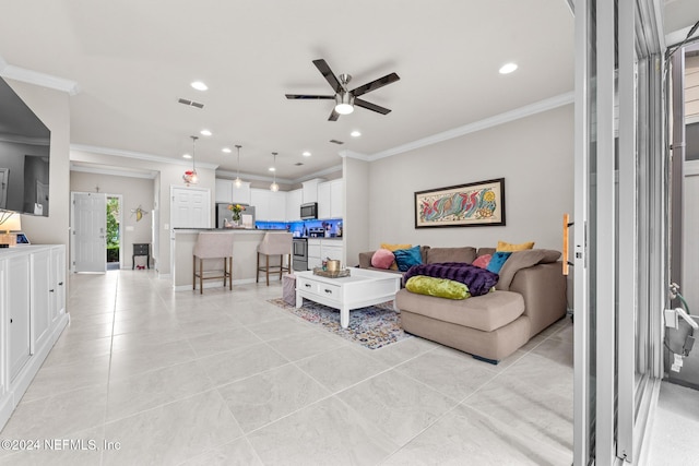 living room featuring ceiling fan and crown molding