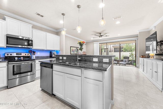 kitchen featuring white cabinets, appliances with stainless steel finishes, sink, and crown molding