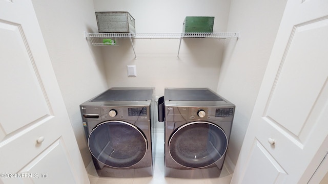 clothes washing area featuring washing machine and clothes dryer