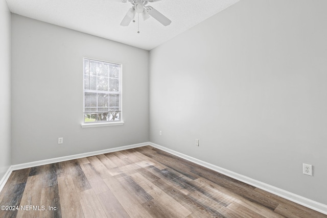 spare room with a textured ceiling, hardwood / wood-style floors, and ceiling fan