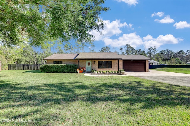 ranch-style home with a front yard and a garage