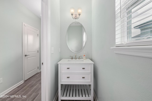 bathroom with hardwood / wood-style floors, vanity, and a wealth of natural light