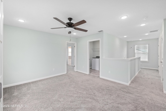 empty room featuring ceiling fan and light carpet