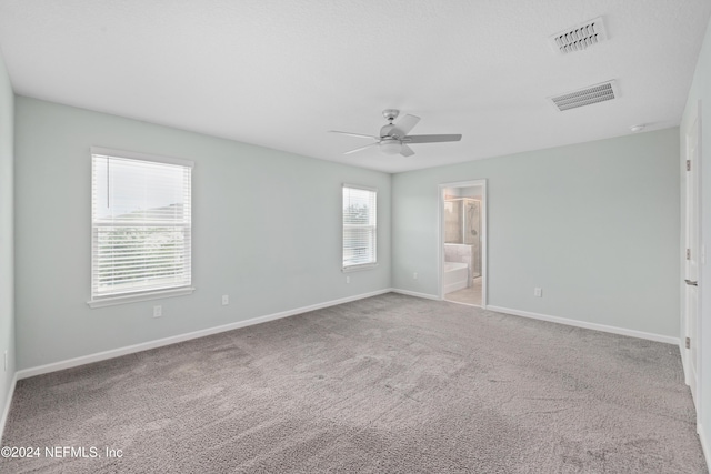 unfurnished room with light colored carpet and ceiling fan