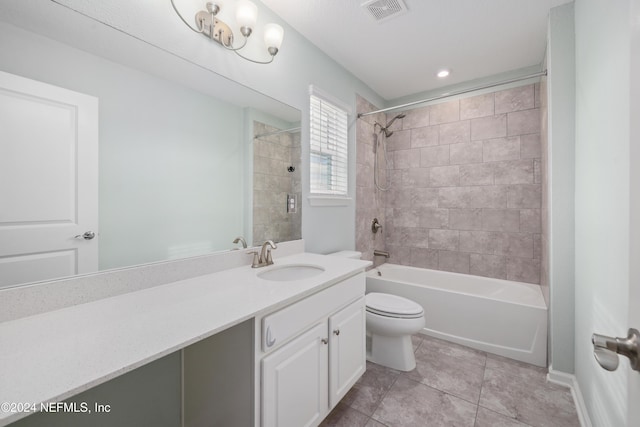 full bathroom featuring tile patterned flooring, vanity, toilet, and tiled shower / bath