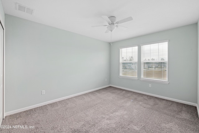 empty room featuring ceiling fan and carpet floors