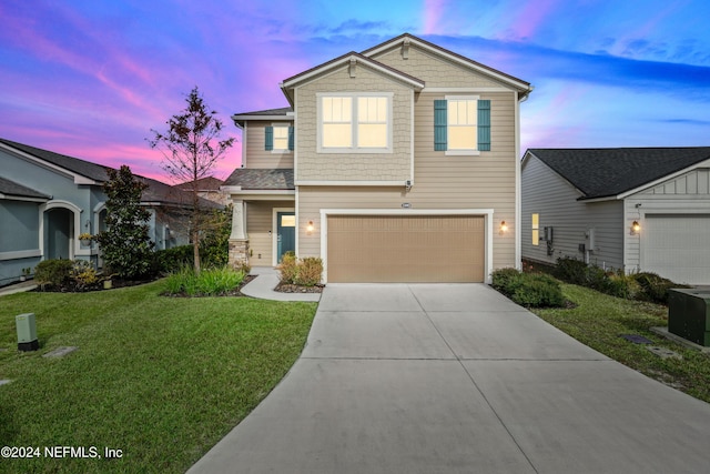 view of front facade with a lawn and a garage