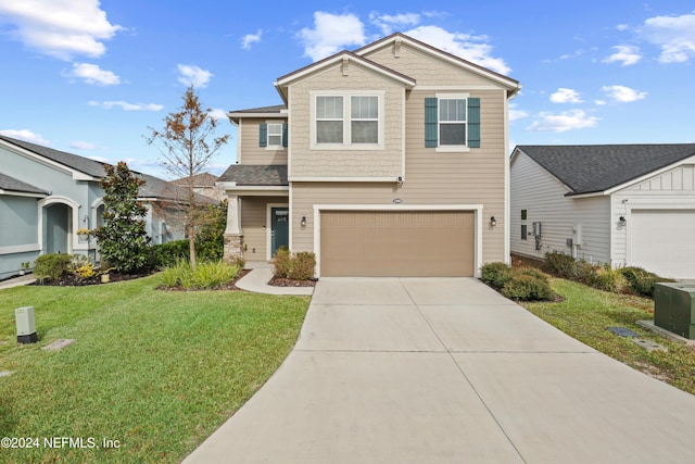 view of front of property featuring a garage and a front yard